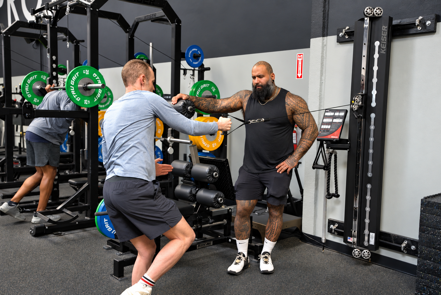 Coach guiding a member through cable training at Project Wellbeing